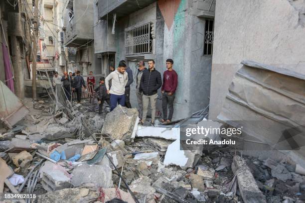 Residents living in the area, examine search for their furniture under the rubbles of the destroyed buildings after Israeli attacks in Rafah, Gaza on...