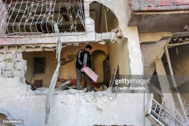 Residents living in the area, examine search for their furniture under the rubbles of the destroyed buildings after Israeli attacks in Rafah, Gaza on...