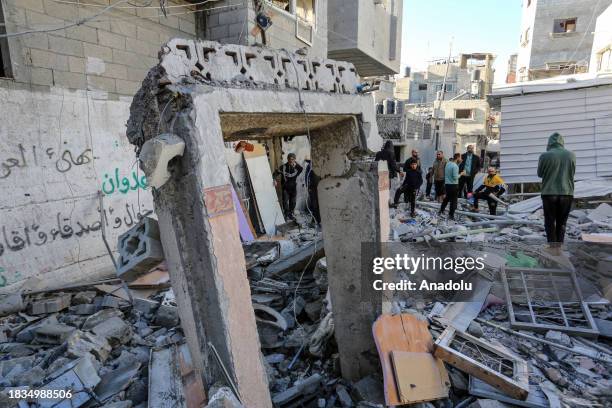 Residents living in the area, examine search for their furniture under the rubbles of the destroyed buildings after Israeli attacks in Rafah, Gaza on...