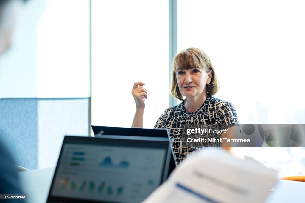Aligning Risk Management with Business Strategy to Enhance Confidence for Your Business. Senior Business Executive in business performance meeting to determine direction with partner in a modern business office. Business Relationship, Corporate Business.