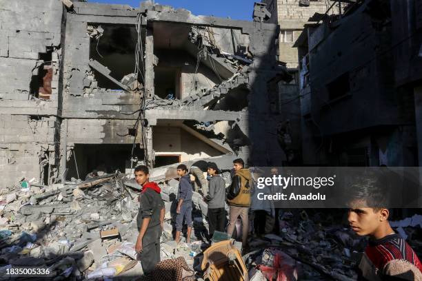 Residents living in the area, examine search for their furniture under the rubbles of the destroyed buildings after Israeli attacks in Rafah, Gaza on...