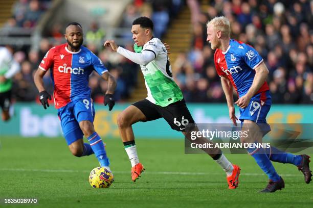 Liverpool's English defender Trent Alexander-Arnold runs past Crystal Palace's French-born Ghanaian striker Jordan Ayew and Crystal Palace's English...