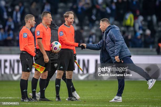Coach Pal Dardai of Hertha BSC greets the referees Sven Jablonski, Martin Dr. Thomsen and Mario Hildenbrand after the Second Bundesliga match between...