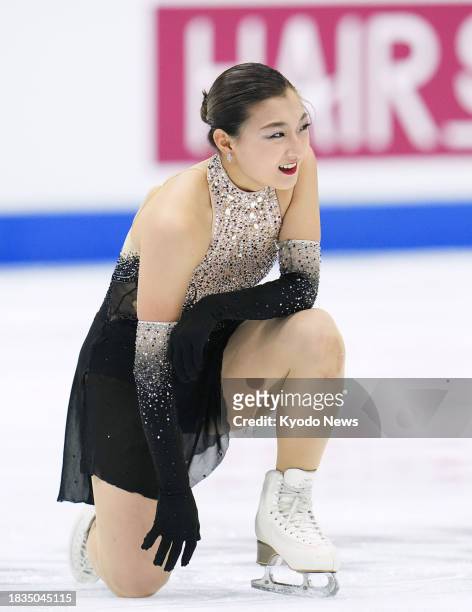 Kaori Sakamoto of Japan smiles after performing in the women's free program at the Grand Prix Final figure skating competition in Beijing on Dec. 9,...