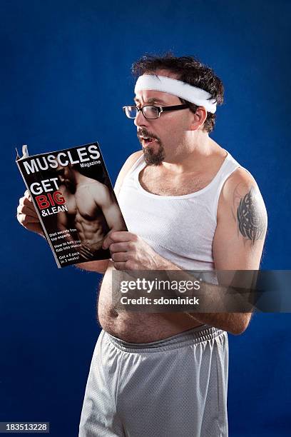 man reading muscle magazine - fat hairy guys stock pictures, royalty-free photos & images