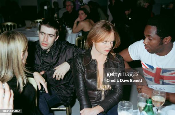 English singer Liam Gallagher and English fashion designer Stella McCartney attend the War Child charity exhibition at the Saatchi Gallery, London,...