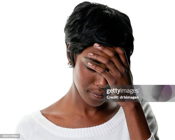 sad young woman looks down and covers eyes - short hair stock pictures, royalty-free photos & images