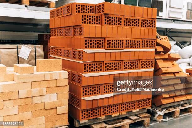 bricks stacked and arranged for sale at a hardware store. - materiale foto e immagini stock