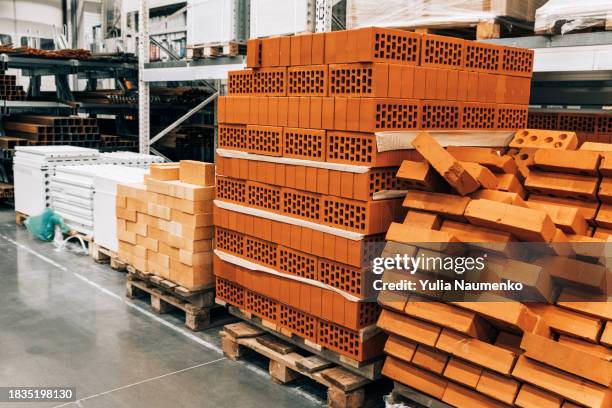 bricks stacked and arranged for sale at a hardware store. - materiale foto e immagini stock