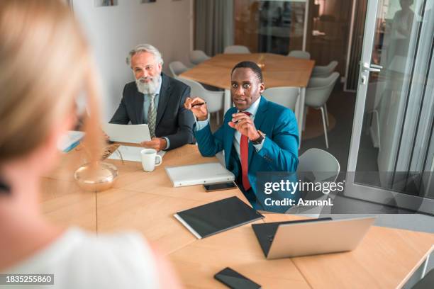 multiracial team shaping future workforce strategies for hr evolution symposium - mature men office stock pictures, royalty-free photos & images