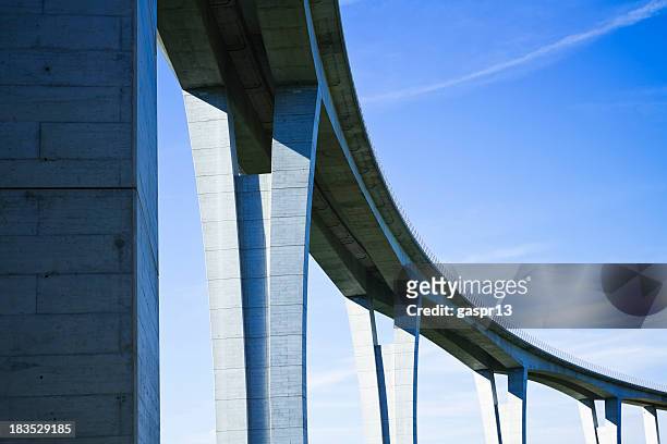 close up of highway viaduct in front of a clear blue sky - bridge stock pictures, royalty-free photos & images