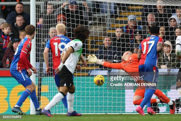 Liverpool's Egyptian striker Mohamed Salah watches as his deflected shot beats Crystal Palace's English goalkeeper Sam Johnstone for their first goal...