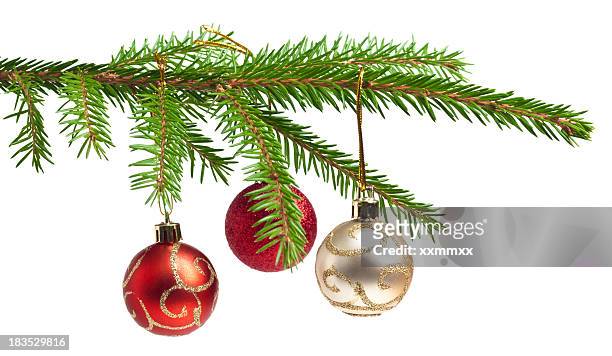 isolated pine tree branch with three christmas balls hanging - twig stockfoto's en -beelden