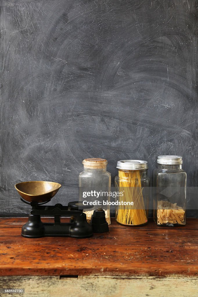 Blackboard with wooden table and glass jars