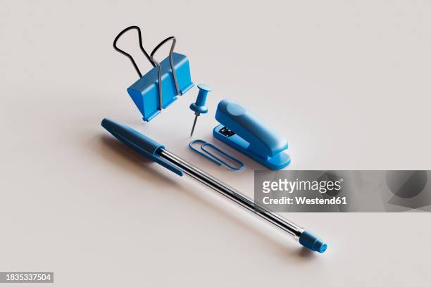 3d render of blue colored office supplies floating against white background - clip stock illustrations