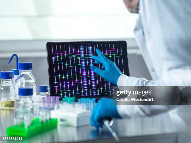 scientist using laptop for genetic research in laboratory - laboratory computer stock pictures, royalty-free photos & images