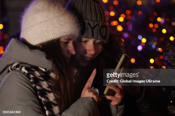 People attend the Christmas tree opening ceremony on the city's Sofia Square on December 6, 2023 in Kyiv, Ukraine. Due to the fact that Ukraine has...