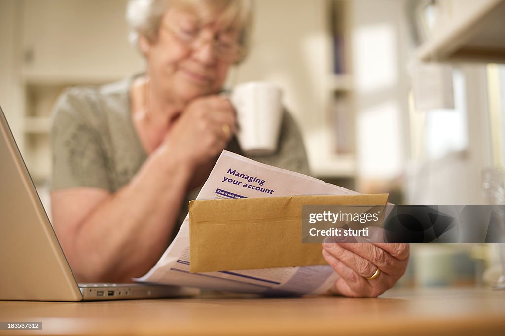 Woman Looking Over a Bank Statement