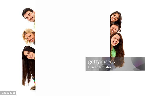 group of six young people peeking behind blank banner sign - happy people holding a white board stock pictures, royalty-free photos & images