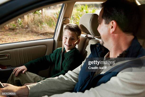 father and son in front seat of car - conversation car bildbanksfoton och bilder