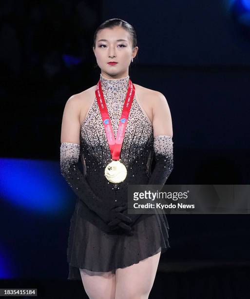 Kaori Sakamoto of Japan poses after winning gold at the Grand Prix Final figure skating competition in Beijing on Dec. 9, 2023.