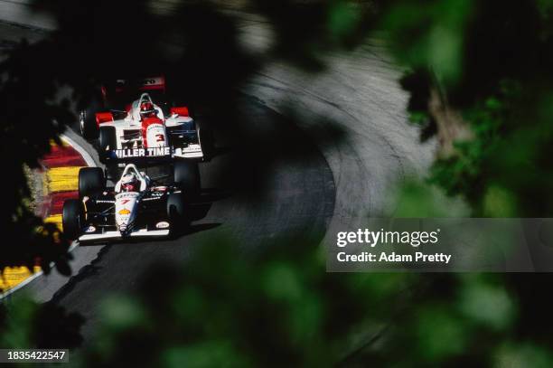 Max Papis from Sweden drives the Miller Lite Team Rahal Lola B01/00 Ford-Cosworth XF ahead Helio Castroneves of Brazil driving the Marlboro Team...