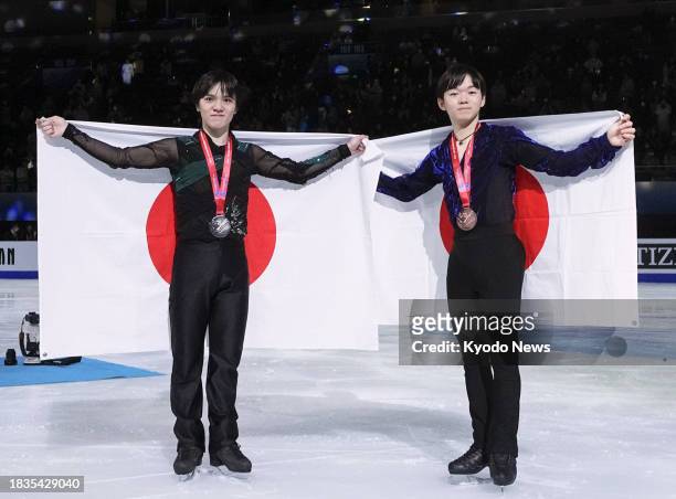 Shoma Uno of Japan and compatriot Yuma Kagiyama pose after winning silver and bronze, respectively, at the Grand Prix Final figure skating...