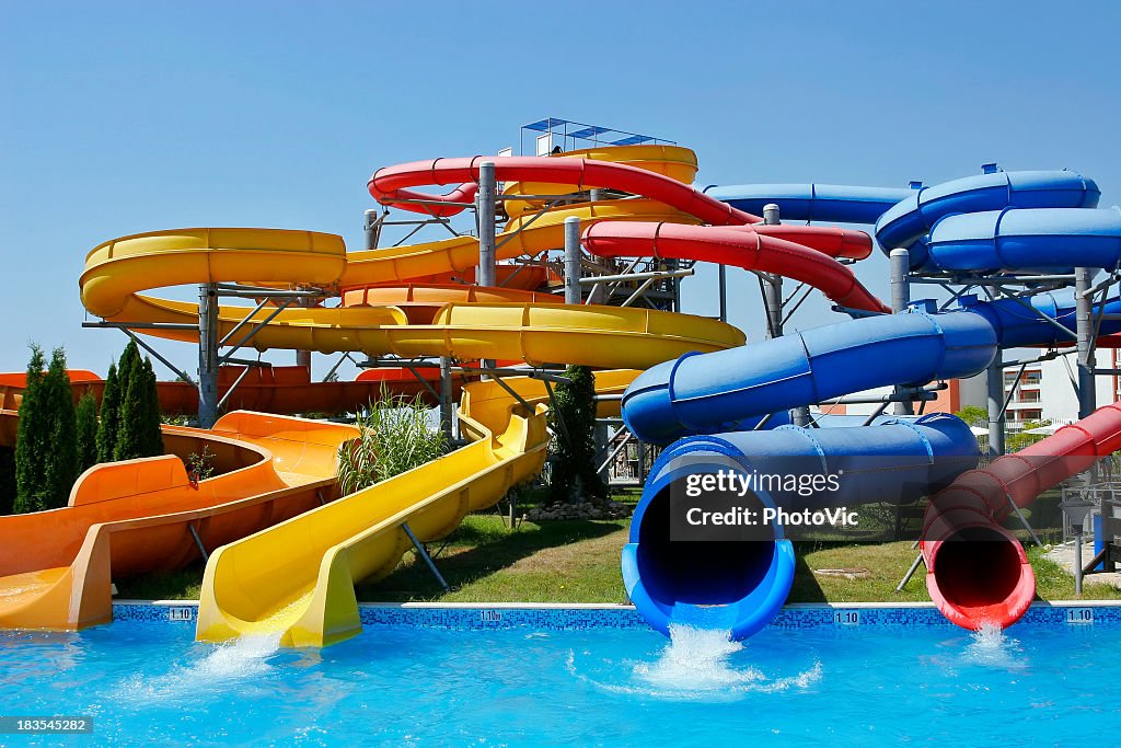 View of four different water park tubes on a clear day 