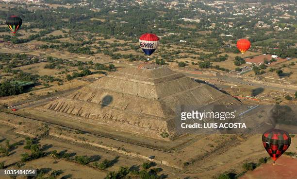 Hot air balloons fly over the Sun Pyramid during the Teotihuacan Hot Air Balloon Festival in San Juan de Teotihuacan, State of Mexico, March 21st,...