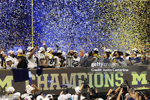 The Michigan Wolverines celebrate winning the Big Ten Championship against the Iowa Hawkeyes at Lucas Oil Stadium on December 02, 2023 in...