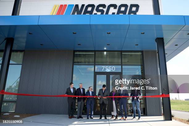 Jim France, NASCAR Chairman and CEO, officially cuts the ribbon as he attends the NASCAR Productions Facility Grand Opening on December 06, 2023 in...