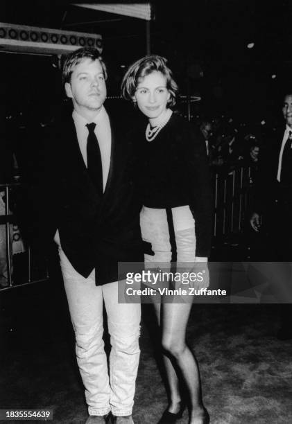 Canadian actor Kiefer Sutherland and American actress Julia Roberts attend the Westwood premiere of 'Sleeping with the Enemy', held at the Mann...