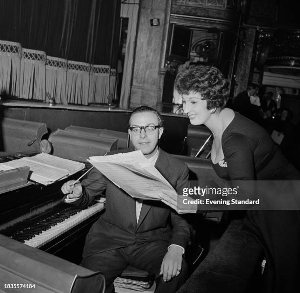 Singer Alma Cogan with songwriter Cyril Ornadel , looking at sheet music during rehearsals for her appearance in the Royal Variety Performance at The...