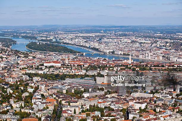 Residential and commercial property stand on the banks of the River Danube in this aerial view of the city skyline in Budapest, Hungary, on Thursday,...
