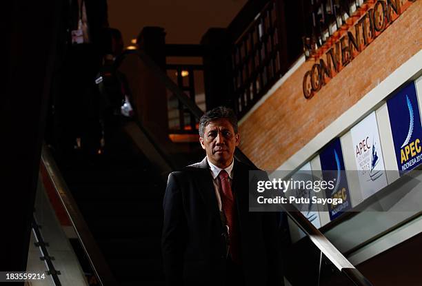 Delegate rides an escalator at the venue of APEC CEO Summit on October 7, 2013 in Nusa Dua, Indonesia. US President Barack Obama has not attended the...