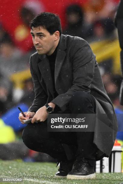 Bournemouth's Spanish manager Andoni Iraola takes notes during the English Premier League football match between Manchester United and Bournemouth at...