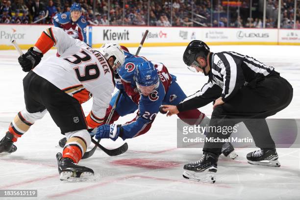 Ross Colton of the Colorado Avalanche faces off against Sam Carrick of the Anaheim Ducks at Ball Arena on December 5, 2023 in Denver, Colorado.