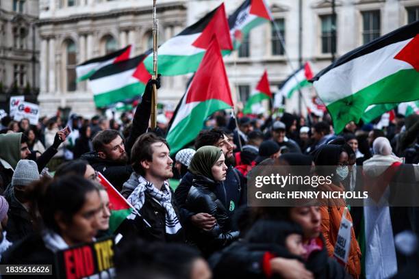 Pro-Palestinian activists and supporters take part in a minute of silence during a National March for Palestine in central London on December 9...