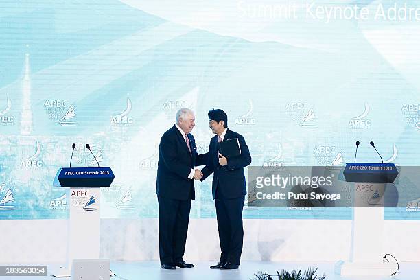 President and CEO Freeport-McMoran Copper & Gold Inc Richard Adkerson shakes hands with Japanese Prime Minister Shinzo Abe as Abe delivers a keynote...