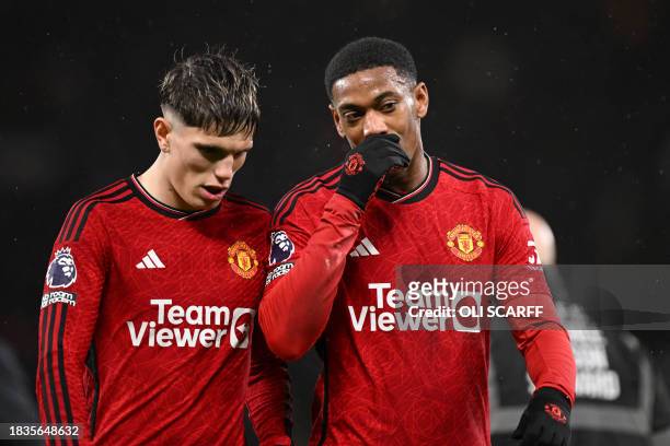 Manchester United's French striker Anthony Martial and Manchester United's Argentinian midfielder Alejandro Garnacho talk as they leave at half-time...