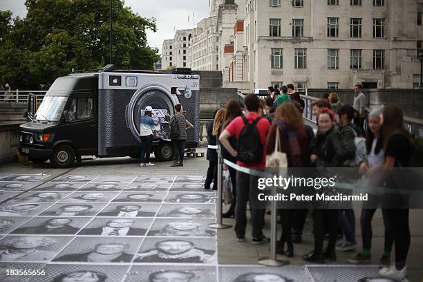 Members of the public line up for the photo booth truck at the Inside Out project at Somerset House on October 7, 2013 in London, England. Displaying...