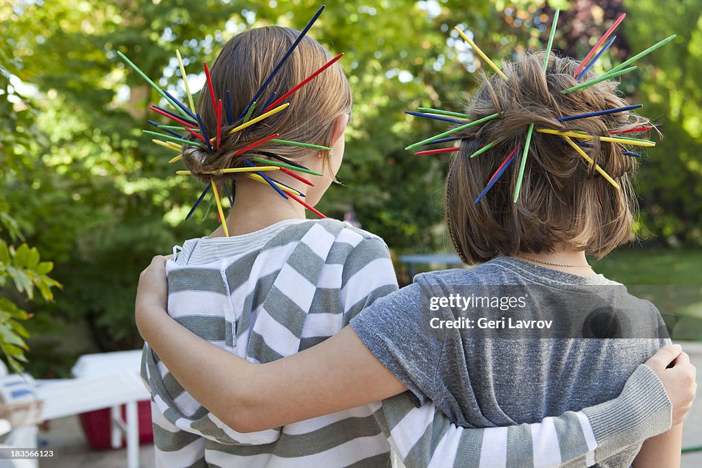 Two young girls embracing each other