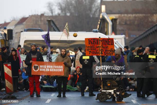 Climate activists blockade Elsenbruecke bridge to demand an end to fossil fuel subsidies on December 9, 2023 in Berlin, Germany. Several hundred...