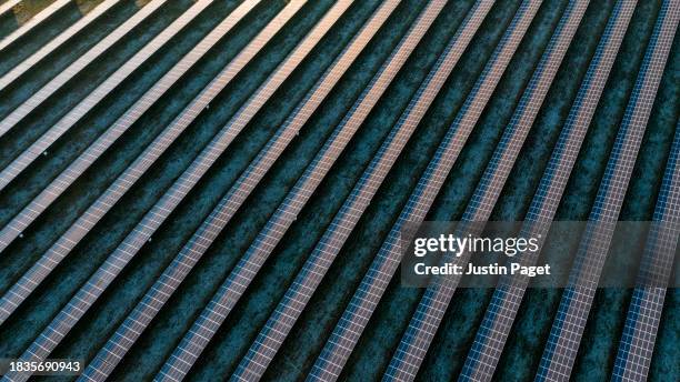 drone/aerial view of solar panels on a cold frosty winter's morning in the uk - sky bar stock pictures, royalty-free photos & images