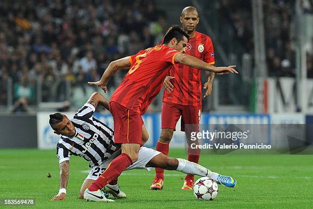 Gokhan Zan of Galatasaray AS is challenged by Arturo Vidal of Juventus during UEFA Champions League Group B match between Juventus and Galatasaray AS...