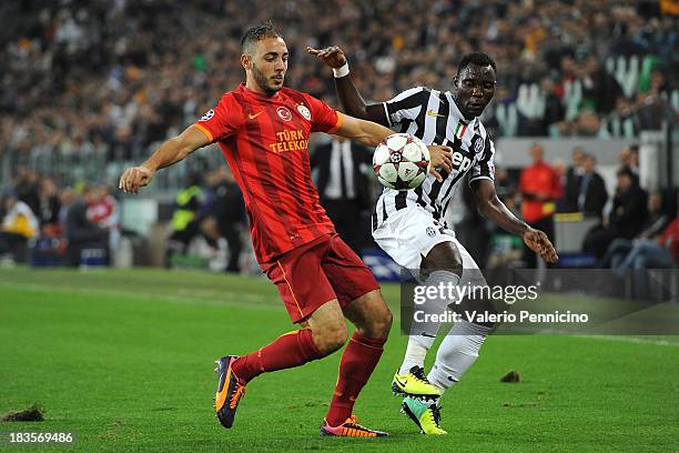 Kwadwo Asamoah of Juventus is challenged by Nordin Amrabat of Galatasaray AS during UEFA Champions League Group B match between Juventus and...