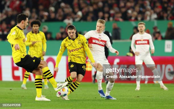 Mats Hummels and Marcel Sabitzer of Borussia Dortmund battle for possession with Chris Fuehrich of VfB Stuttgart during the DFB cup round of 16 match...
