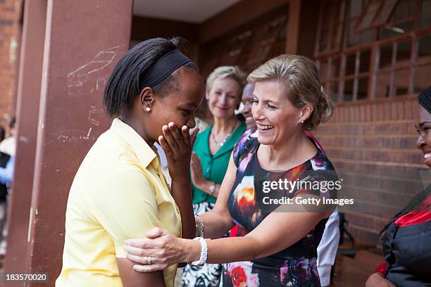 Sophie Countess of Wessex meets a learner at Jabulile School on October 7, 2013 in Orange Farm, South Africa. The Earl and Countess of Wessex are on...