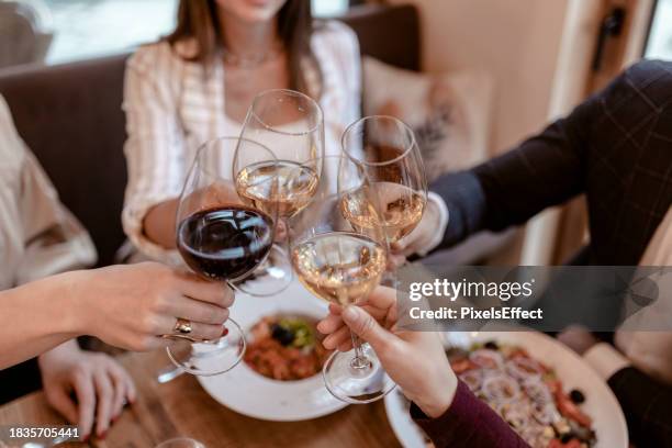 people toast with glasses of wine in a restaurant - honour board stock pictures, royalty-free photos & images