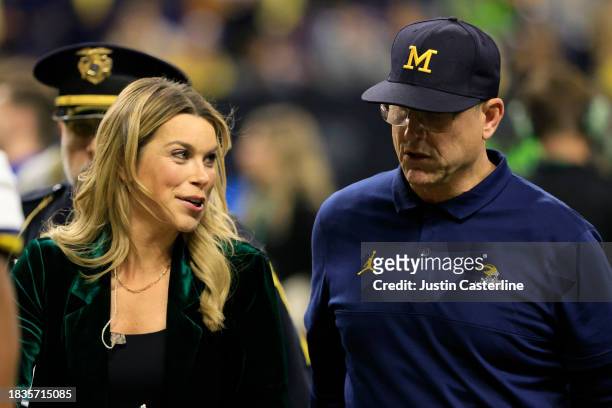 Head coach Jim Harbaugh of the Michigan Wolverines speaks with FOX Sports Sideline report Jenny Taft at halftime of the game against the Iowa...